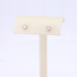 Load image into Gallery viewer, Gold stud earrings with clear cubic zirconia stones, classic and elegant for any occasion.