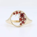 Load image into Gallery viewer, Gold ring featuring red gemstones and delicate white accents in a modern wave design.