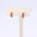 Load image into Gallery viewer, Ruby Huggie Earrings in Yellow Gold