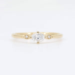 Load image into Gallery viewer, Gold oval diamond ring with two smaller diamonds, elegant minimalist design for a timeless look.