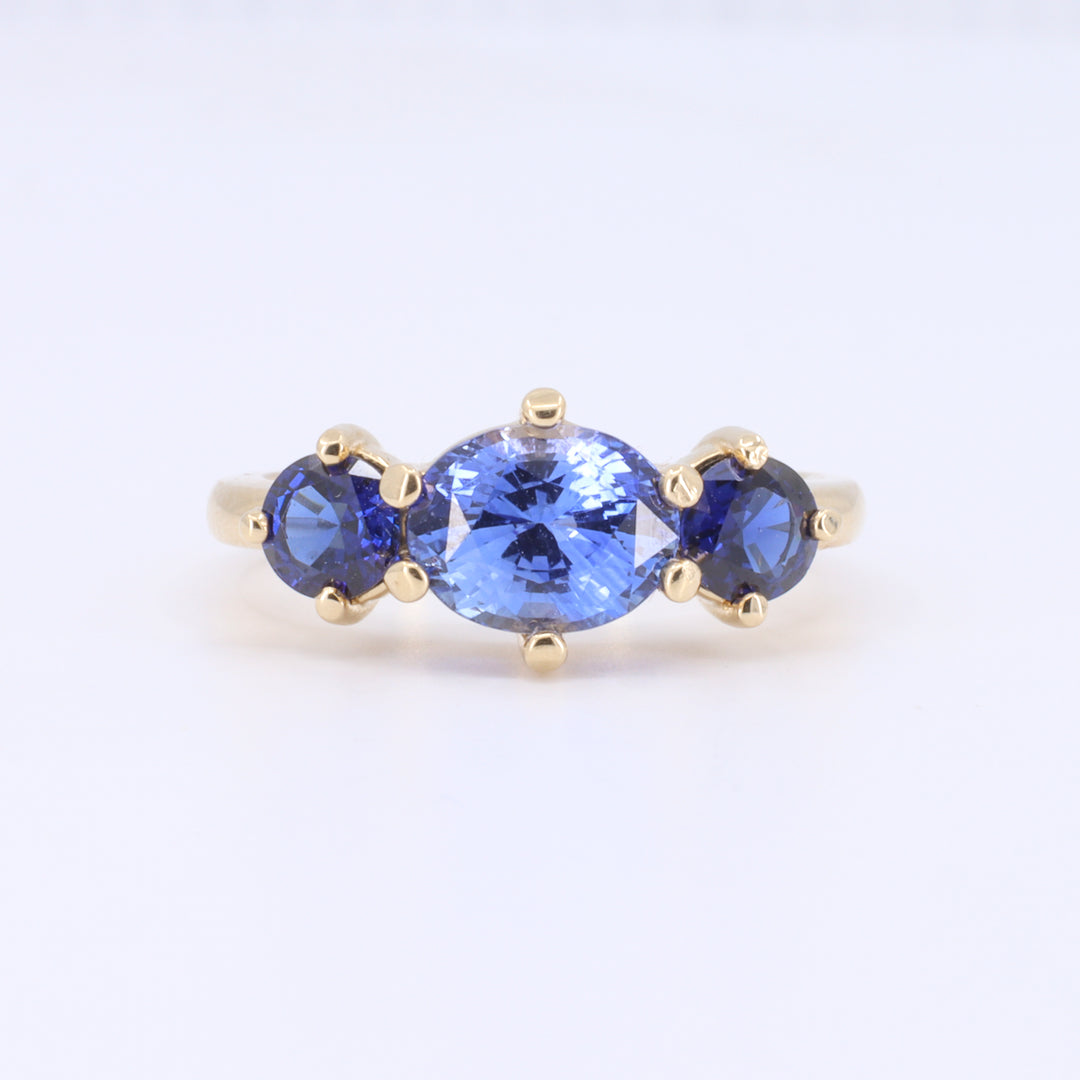 Three Stone Sapphire Ring with East West Set Oval Center set in Yellow Gold