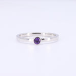 Load image into Gallery viewer, Sterling silver ring featuring a round, purple amethyst gemstone in a minimalist design.