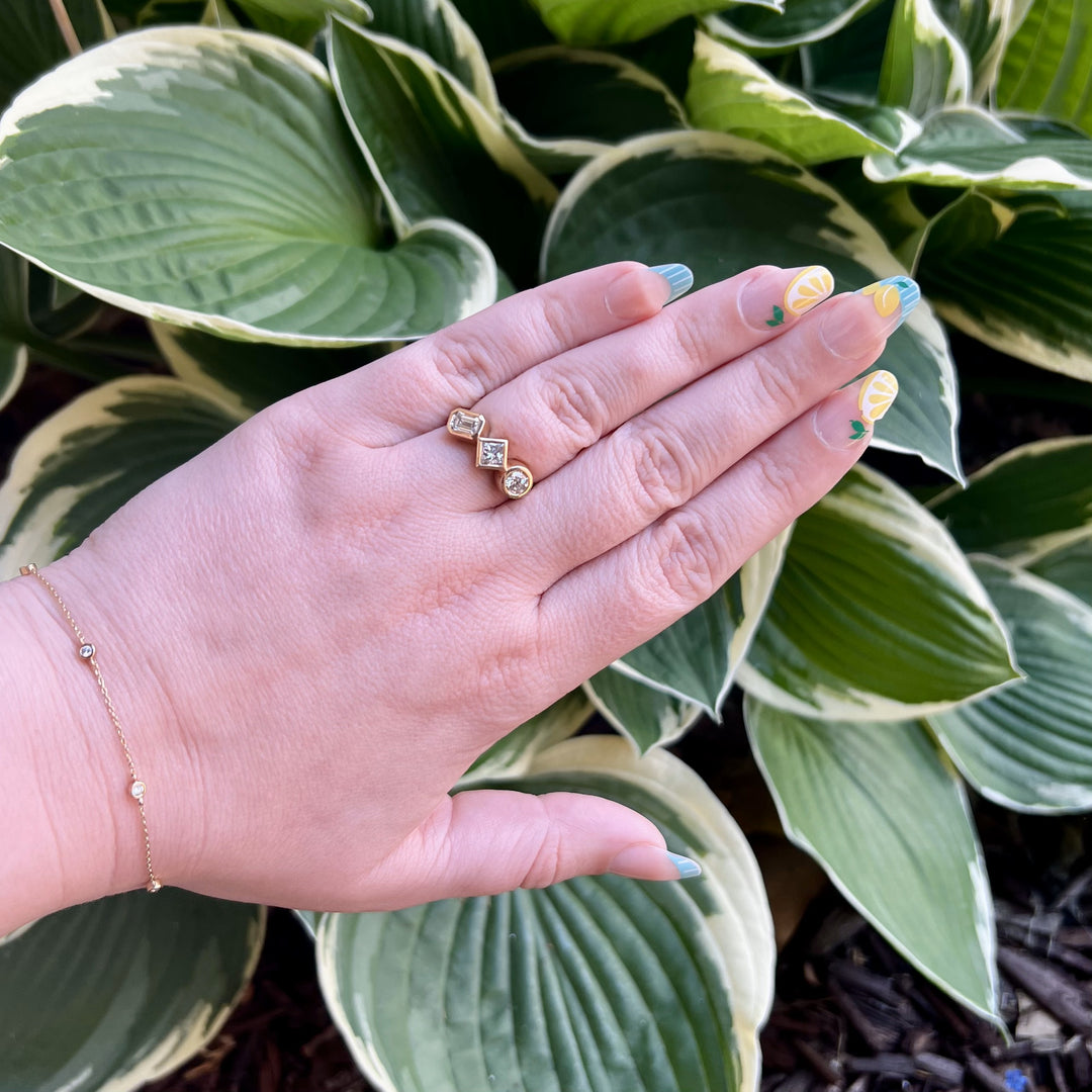 Bezel Set Three Stone Engagement Ring with an Emerald Cut, Round and Princess Cut Diamond