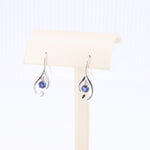 Load image into Gallery viewer, Silver filigree drop earrings with blue crystals, elegant and lightweight, perfect for any occasion.