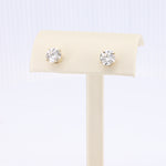 Load image into Gallery viewer, Gold stud earrings with clear round cubic zirconia stones, perfect for elegant everyday wear.
