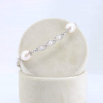 Load image into Gallery viewer, Delicate silver bracelet with white pearls and intricate detailing, perfect for elegant occasions.