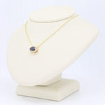 Load image into Gallery viewer, Gold gemstone necklace featuring a blue oval sapphire pendant on a delicate chain, perfect for elegant occasions.