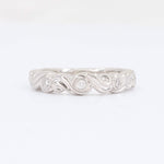 Load image into Gallery viewer, Elegant white gold band ring with twisting design and sparkling diamonds, perfect for wedding or anniversary gifts.