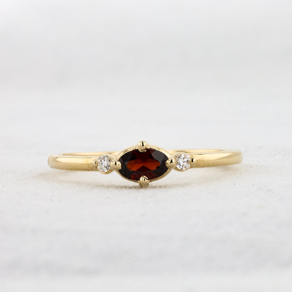 East-West Oval Garnet Ring with Diamond Trim in Yellow Gold