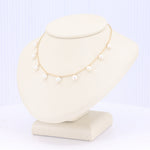 Load image into Gallery viewer, Delicate gold necklace with white pearls, perfect for elegant occasions or everyday wear.