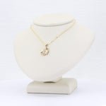 Load image into Gallery viewer, Gold sunburst pendant necklace with a sparkling diamond centerpiece on a delicate chain, perfect for stylish outfits.