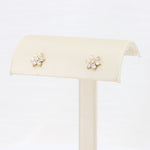 Load image into Gallery viewer, Gold flower stud earrings with sparkling cubic zirconia, elegant and perfect for formal or casual occasions.