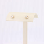 Load image into Gallery viewer, Gold stud earrings with sparkling crystal halo, elegant design, perfect for formal and casual occasions.