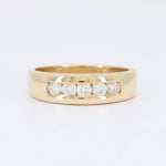 Load image into Gallery viewer, Yellow gold band ring featuring five sparkling round diamonds in a channel setting. Elegant and modern design.