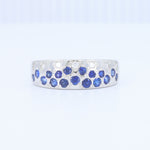 Load image into Gallery viewer, Sapphire and diamond-studded silver band ring with a modern design, featuring blue gemstones and a polished finish.