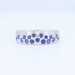 Load image into Gallery viewer, Silver band ring with blue sapphires and white diamonds in a floral design, sparkling and elegant.