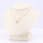 Load image into Gallery viewer, Gold chain necklace featuring a sparkling cubic zirconia pendant on a beige display. Elegant and timeless design.