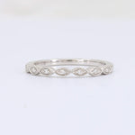 Load image into Gallery viewer, White gold eternity band ring with diamond accents, featuring an elegant wavy design. Perfect for wedding or fashion jewelry.