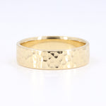 Load image into Gallery viewer, Gold hammered wedding band in a sleek, polished finish, featuring a textured surface for a modern, elegant look.