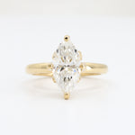 Load image into Gallery viewer, Gold two-stone engagement ring featuring a marquise cut diamond in a elegant, modern design.