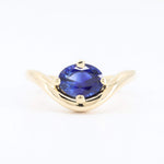 Load image into Gallery viewer, Elegant gold ring featuring an oval blue sapphire, showcasing a modern wave design. Perfect for special occasions.