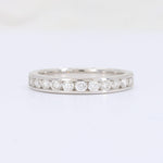 Load image into Gallery viewer, White gold eternity ring featuring round brilliant-cut diamonds, perfect for elegant and timeless jewelry styles.