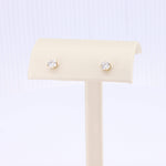 Load image into Gallery viewer, Gold-plated stud earrings featuring round, sparkling cubic zirconia stones. Elegant and timeless accessory.