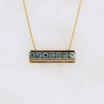 Load image into Gallery viewer, Gold bar necklace with aqua-blue gemstones, featuring sleek, modern design and delicate chain. Perfect for layering.