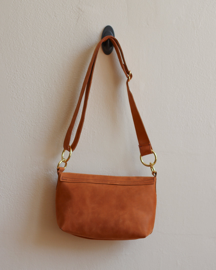 Tan Leather Crossbody Bag with Adjustable Strap and Brass Hardware