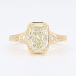 Load image into Gallery viewer, Elegant vintage-style gold ring with a large rectangular diamond and side accent stones, showcasing intricate detailing.