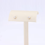 Load image into Gallery viewer, Elegant gold stud earrings with sparkling cubic zirconia stones, perfect for everyday wear or special occasions.