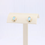 Load image into Gallery viewer, Opal Oval Bezel Set Stud Earrings in Yellow Gold