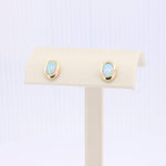 Load image into Gallery viewer, Gold-inspired stud earrings with white opal stones, showcasing a classic and elegant style. Perfect for any occasion.