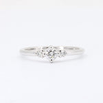 Load image into Gallery viewer, White gold engagement ring featuring a center diamond with two smaller side diamonds, vintage-inspired design.
