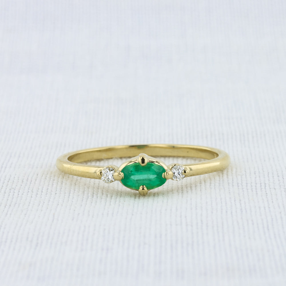 East-West Oval Emerald Ring with Diamond Trim in Yellow Gold