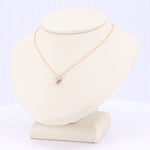 Load image into Gallery viewer, Rose gold necklace featuring a delicate chain and a sparkling cubic zirconia pendant in a floral design.