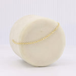 Load image into Gallery viewer, Elegant gold twisted chain bracelet on a cream velvet display, perfect for any sophisticated ensemble.