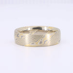 Load image into Gallery viewer, Gold and silver damascus steel ring with intricate wavy patterns, sleek and stylish design for modern elegance.