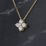 Load image into Gallery viewer, Gold floral necklace featuring four sparkling round diamonds on a delicate chain. Perfect for elegant occasions.