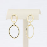 Load image into Gallery viewer, Gold-tone hoop earrings with interlocking circular designs, perfect for a modern, chic look.