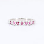 Load image into Gallery viewer, Silver band ring featuring alternating pink gemstones in a modern, elegant design. Perfect for everyday wear.
