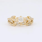 Load image into Gallery viewer, Gold leaf design ring set with a central clear diamond and accent stones, perfect for elegant occasions.