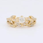 Load image into Gallery viewer, Gold leaf design ring set with a central clear diamond and accent stones, perfect for elegant occasions.