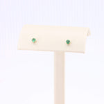 Load image into Gallery viewer, Emerald green gemstone stud earrings in gold settings, elegant and timeless design for everyday wear.