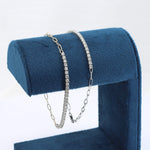 Load image into Gallery viewer, Silver and gold bracelet set with sparkling cubic zirconia on a plush blue display stand. Elegant and modern style.