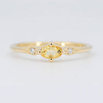 Load image into Gallery viewer, Gold ring with a yellow oval gemstone and side diamonds, featuring a delicate and elegant design.