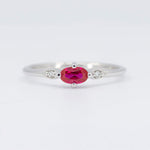 Load image into Gallery viewer, Elegant silver ring featuring a central oval ruby and two sparkling diamond accents. Perfect for any occasion.