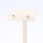Load image into Gallery viewer, Silver stud earrings with light blue crystals, classic and elegant design, perfect for any occasion.