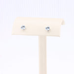 Load image into Gallery viewer, Silver stud earrings with light blue cubic zirconia stones, elegant design perfect for any occasion.