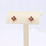 Load image into Gallery viewer, Gold floral stud earrings with pink gemstones, perfect for elegant and stylish outfits.